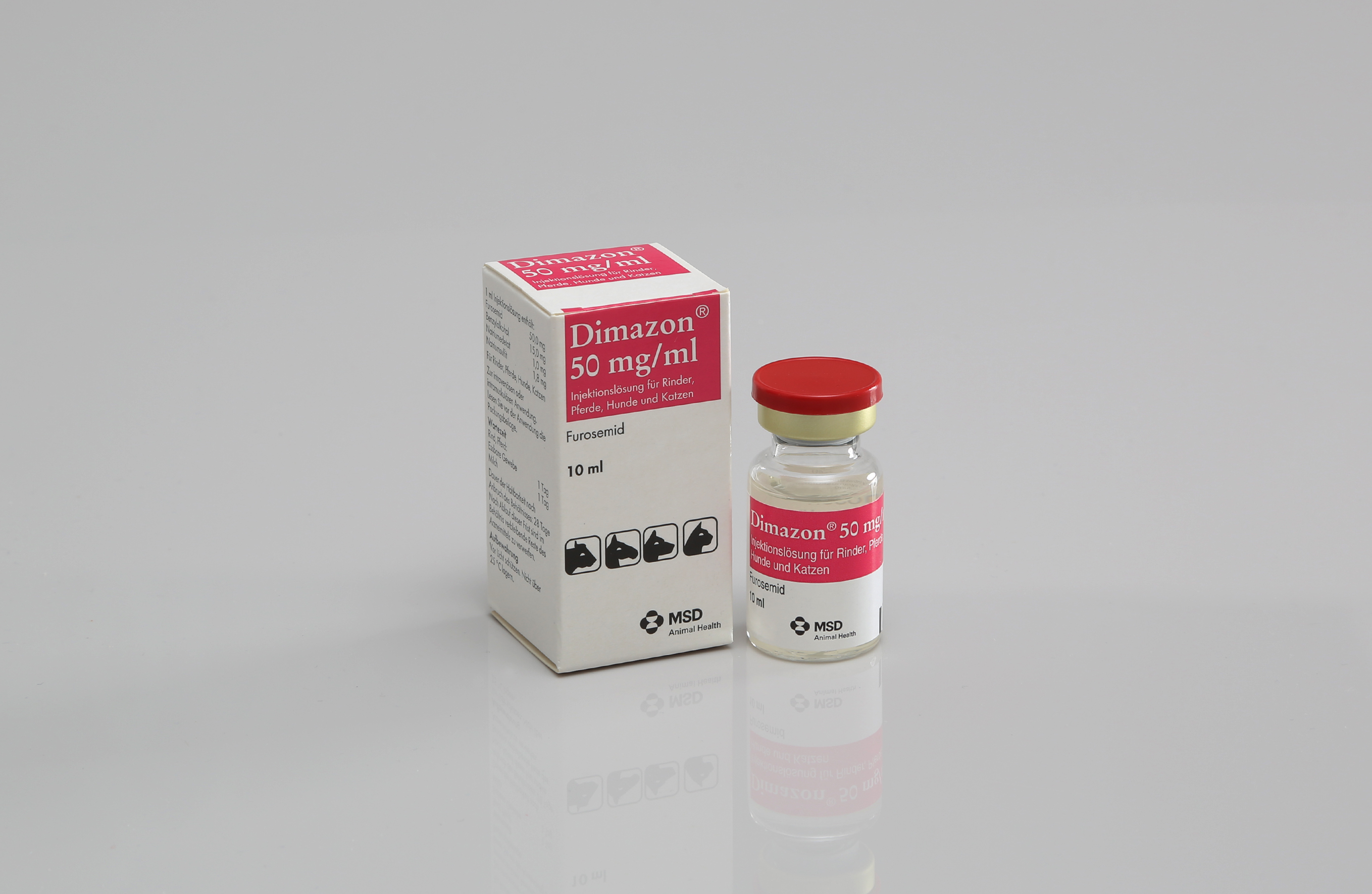 Dinazon 50 mg/ml-Durchstechflasche mit rotem Verschluss neben rosa-weißem Karton.